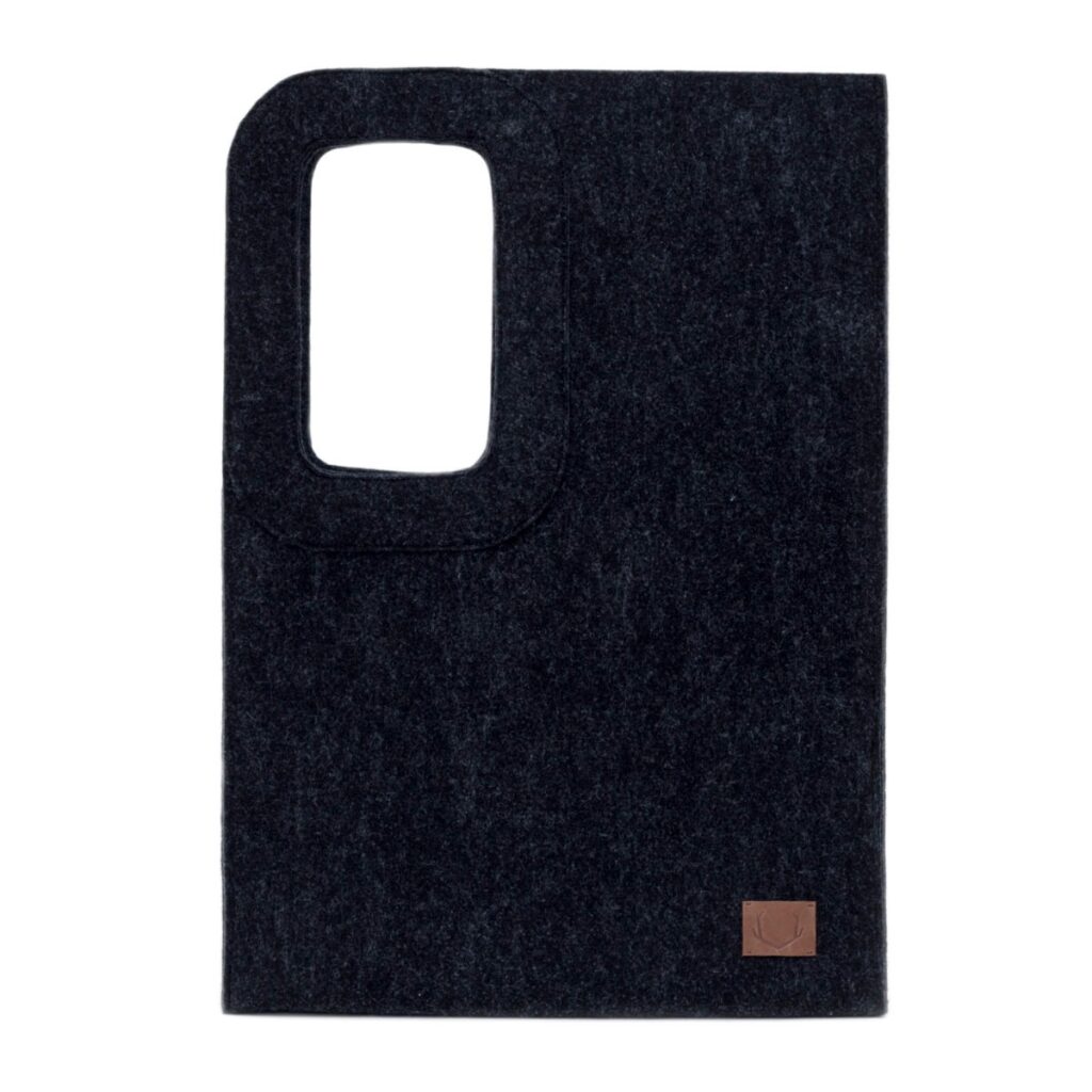 Black Nord tote with a cut-out handle on a pale studio background.