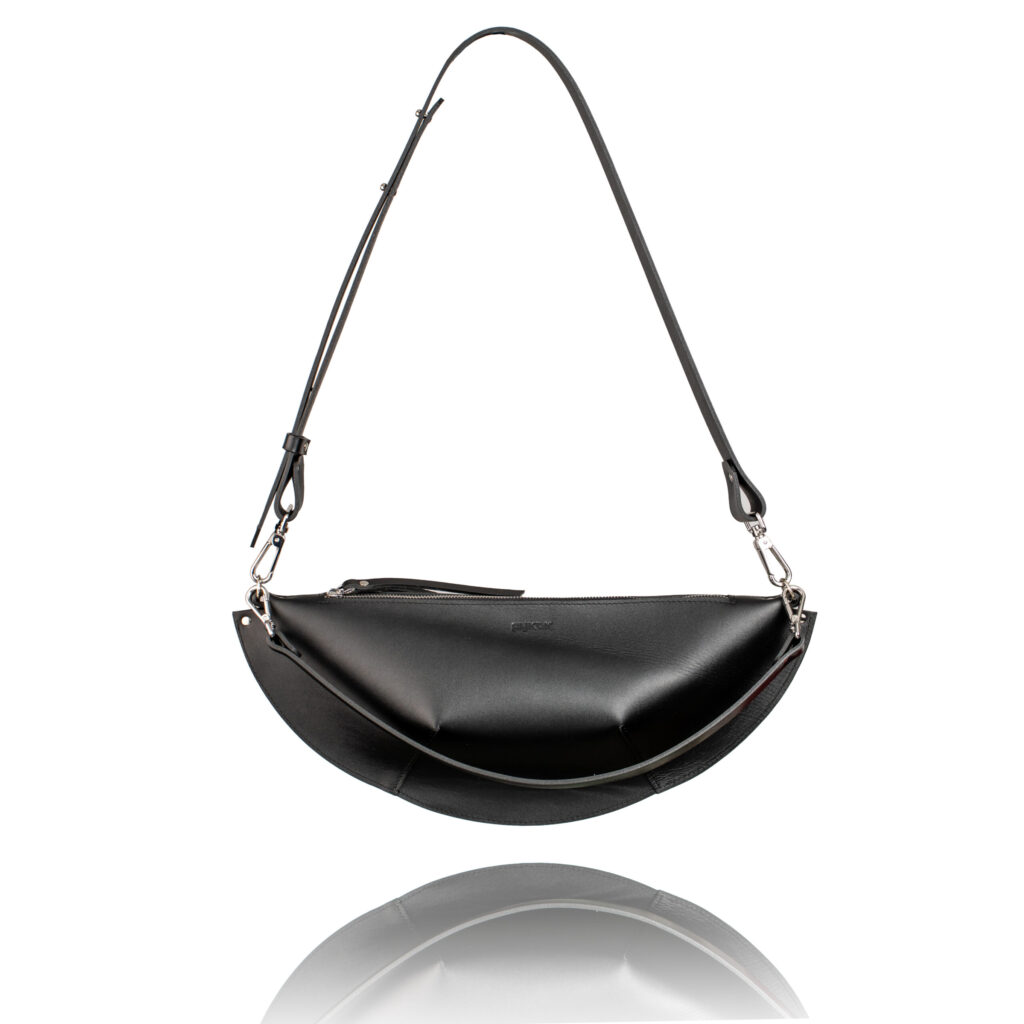 Black crescent-shaped Olivia leather shoulder bag on a white background.